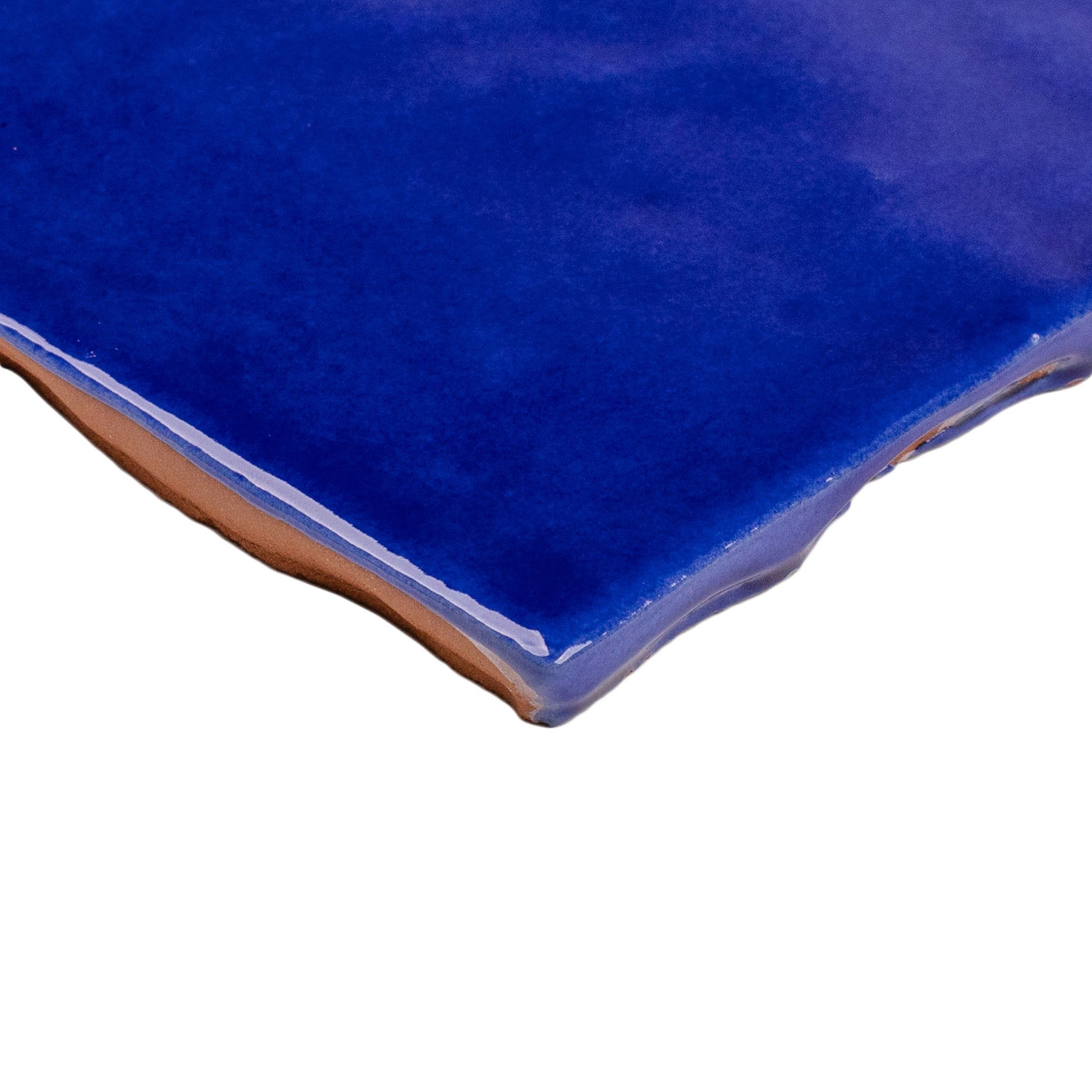 Sapphire Glossy Ceramic Tile in deep blue with handcrafted zellige texture from Small Format Tiles and Zel Glazed Ceramic Tiles collections