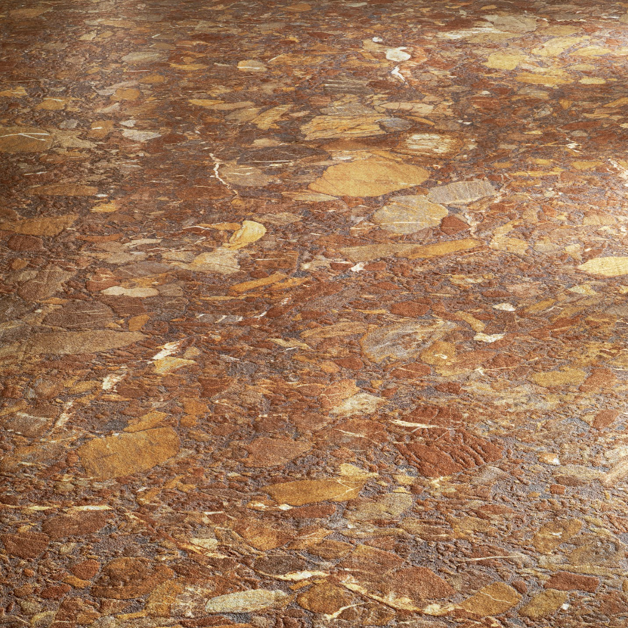 Rustic textured floor featuring irregular natural stone patterns in warm brown and golden tones under soft lighting.