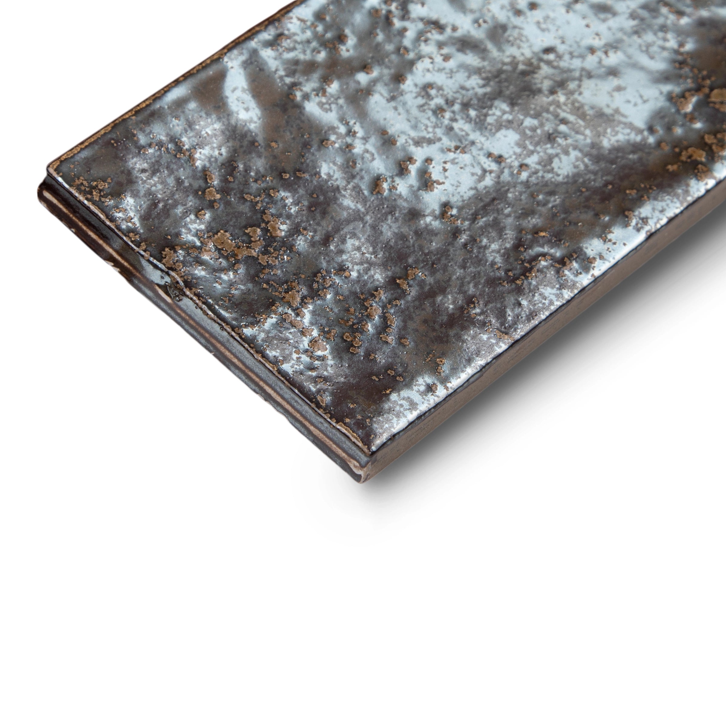 Single narrow porcelain tile in aged silver with a rugged, reflective surface and natural textured variations