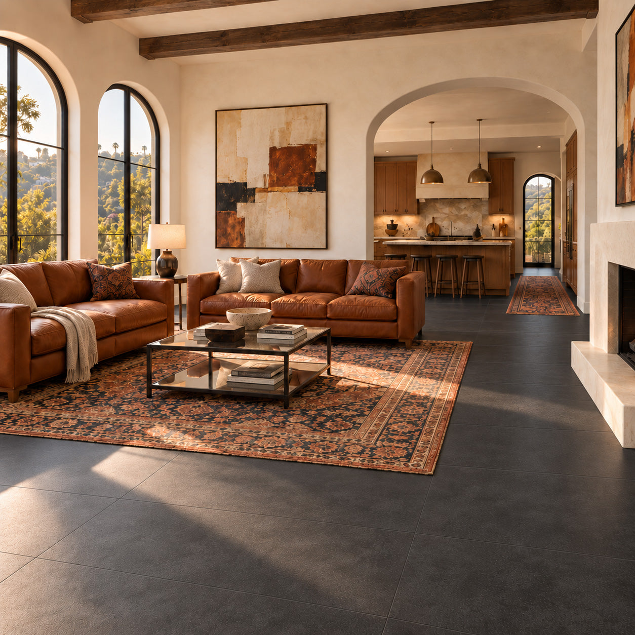 Warm living room with leather sofas patterned rugs arched windows exposed beams and dark tile flooring