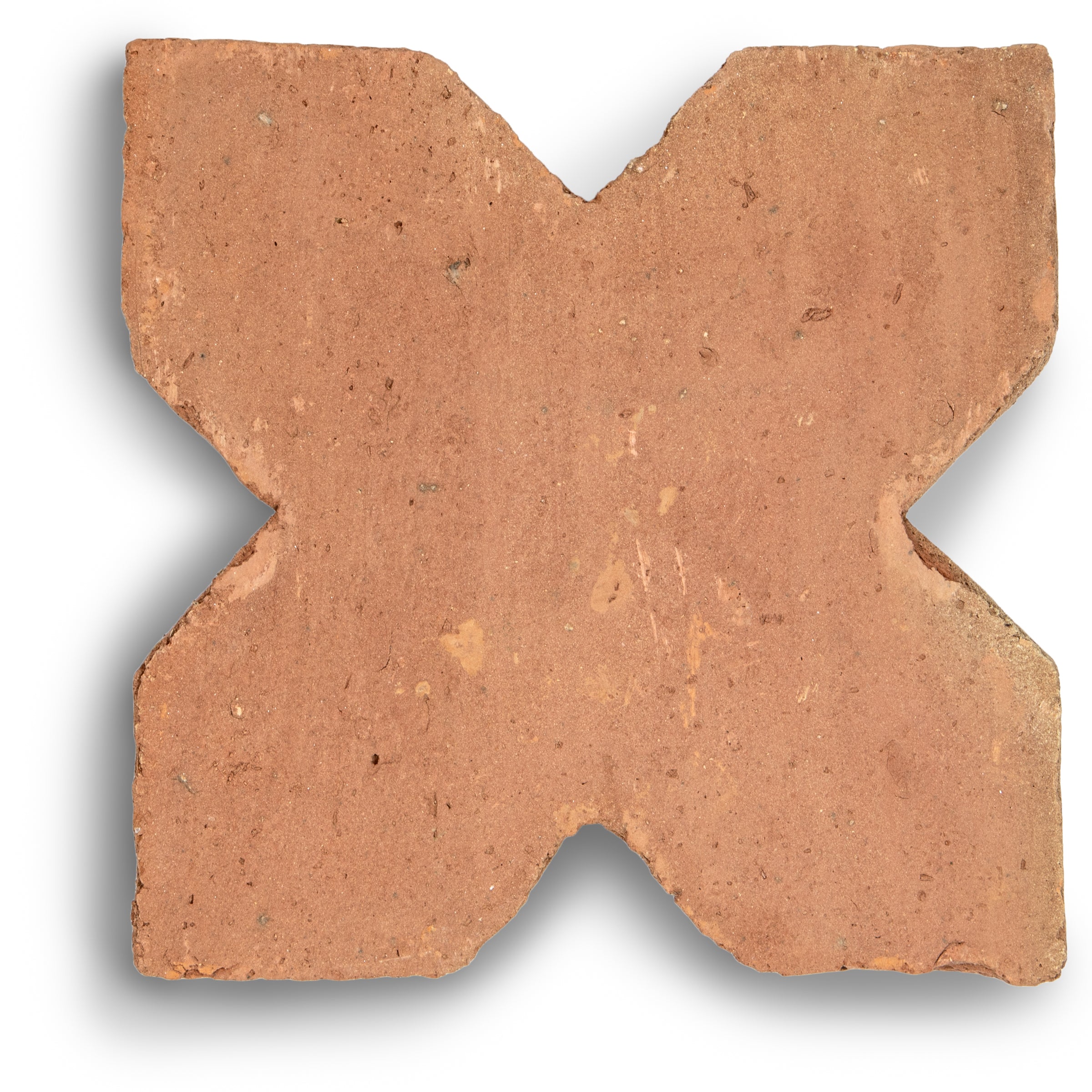 Single terracotta tile in a star and cross shape with natural texture and warm earthy tones on white background