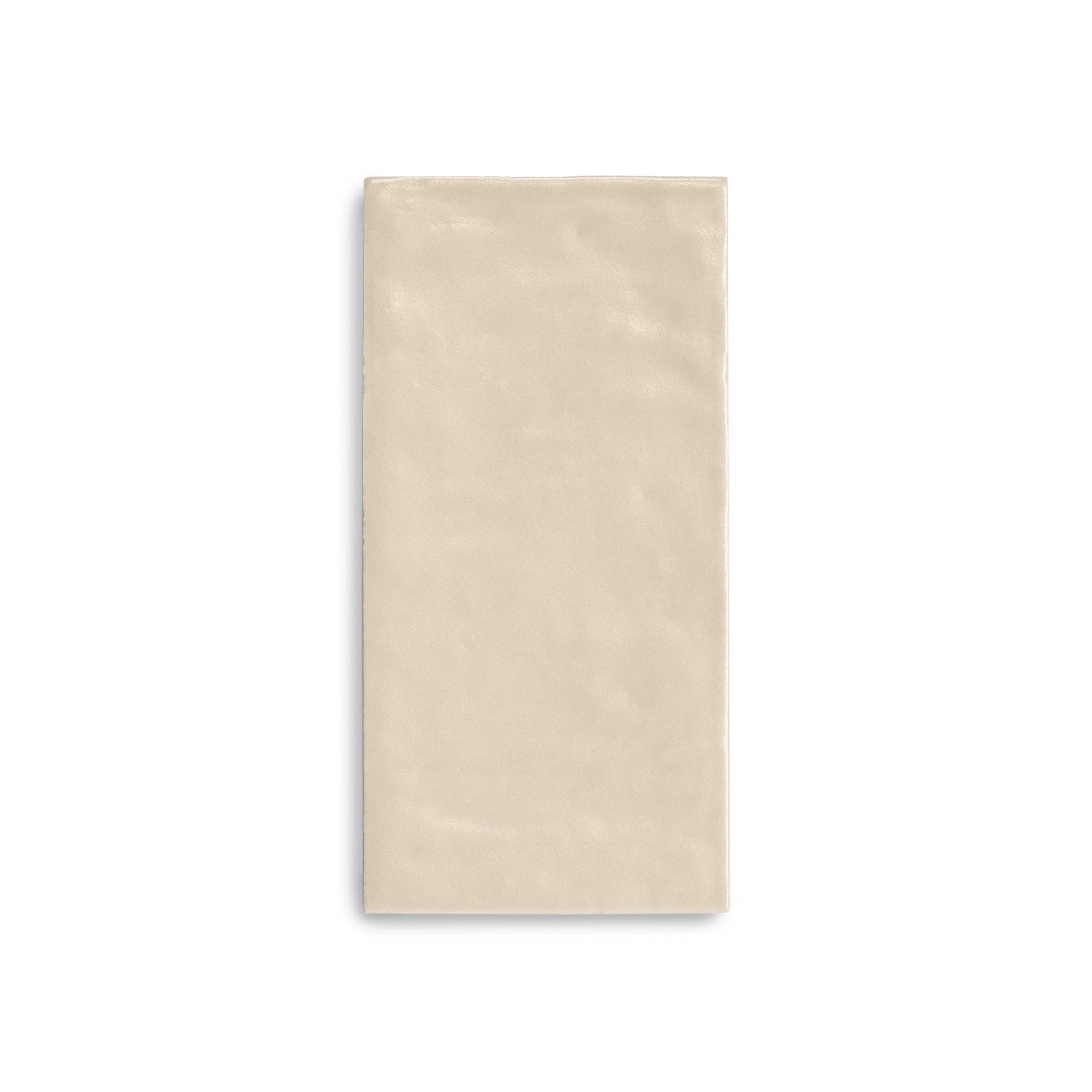 Rectangular porcelain tile in a soft sandy beige tone with a subtle textured surface on a white background