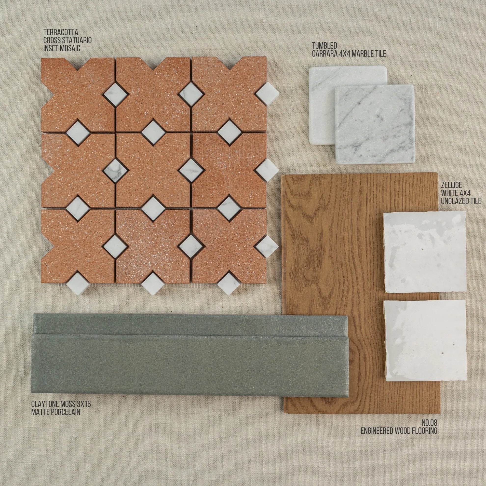 Collection of terracotta mosaic, marble, porcelain, and white unglazed tiles paired with oak engineered wood flooring sample on fabric