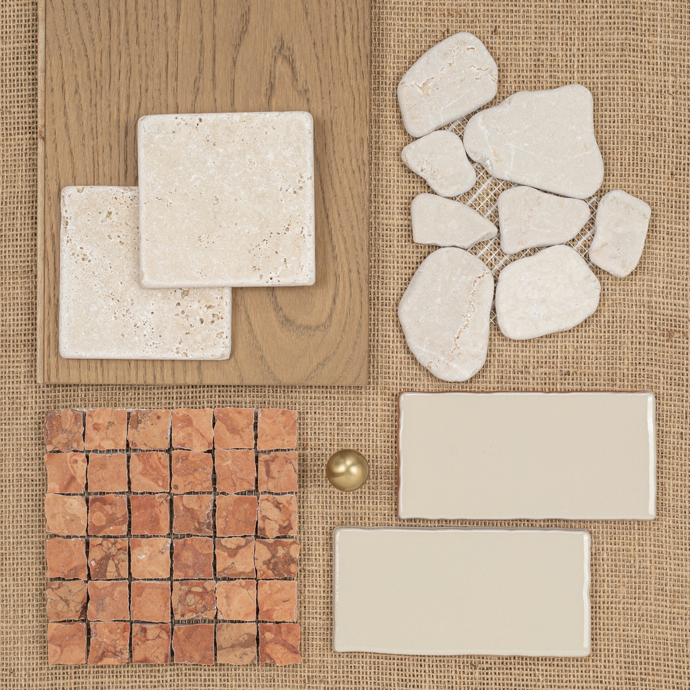 Arrangement of natural stone, terracotta, and ceramic tiles in warm beige and brown tones with wood and brass accents