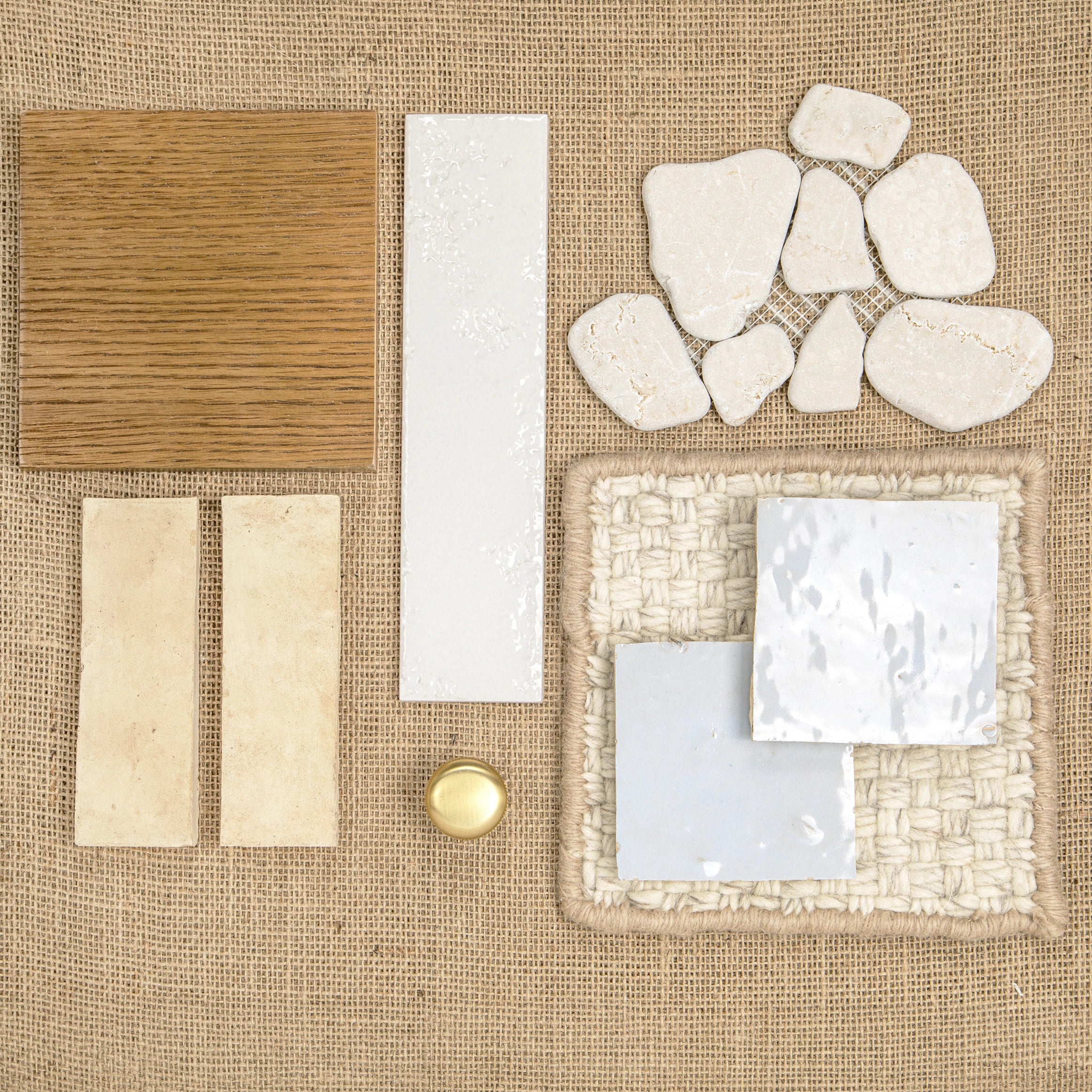 Assorted natural textures and off-white ceramic tiles with warm wood and woven fabric swatches on burlap background