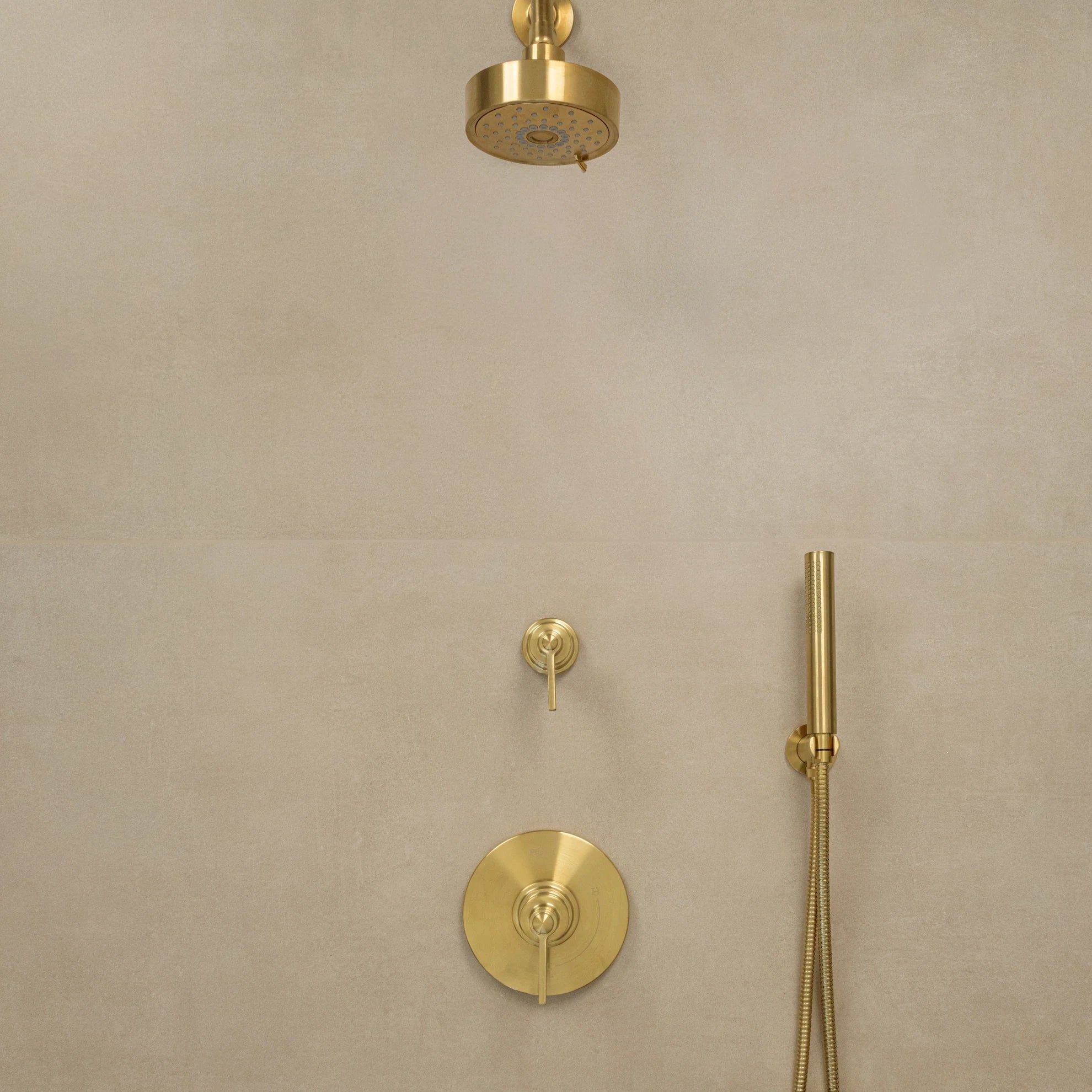 Gold shower fixtures mounted on a beige tiled wall, including a rainfall showerhead, hand shower, and controls