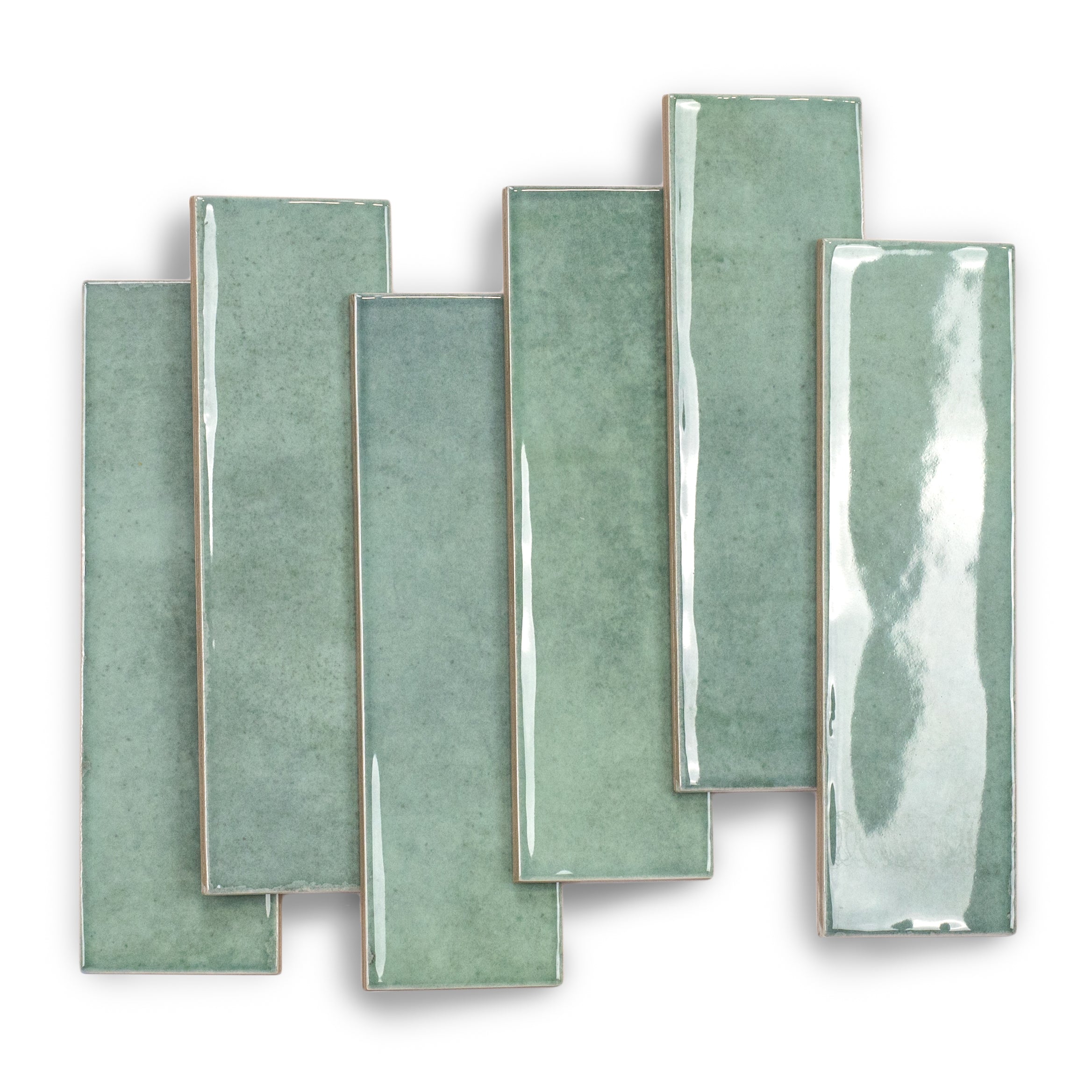 Glossy rectangular ceramic tiles in varied soft turquoise shades arranged overlapping on a white surface