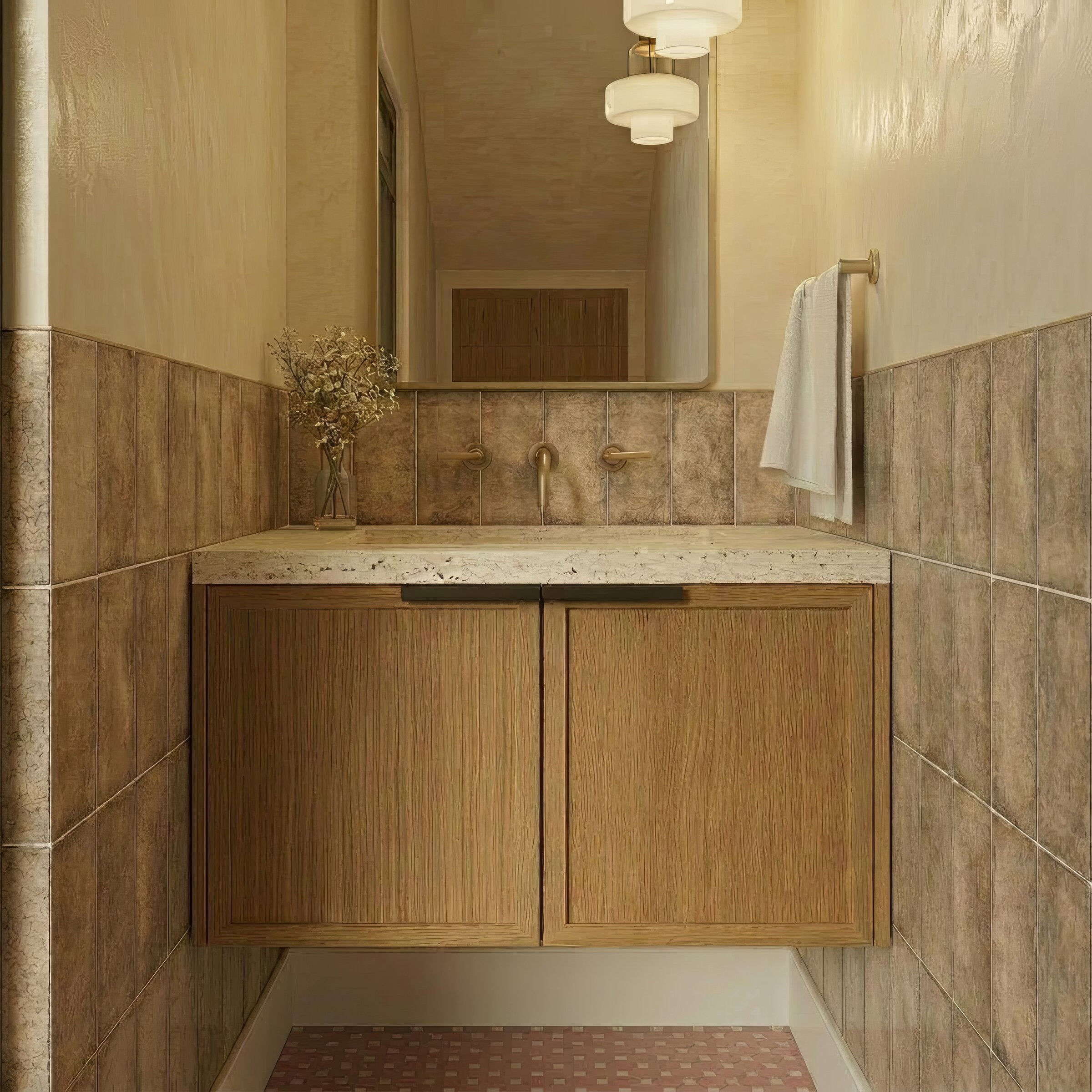 Compact bathroom with floating oak vanity, speckled stone countertop, textured brown wall tiles, and soft neutral lighting