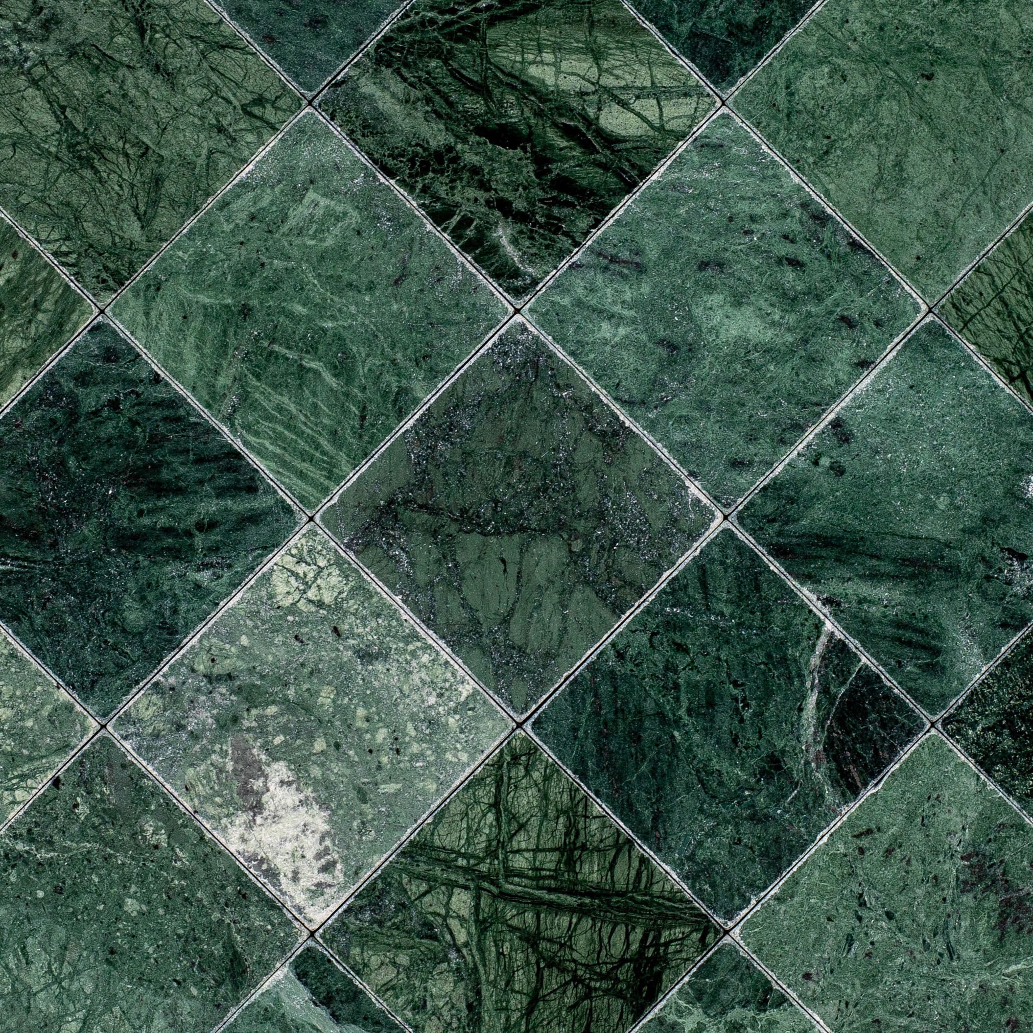 Verde Guatemala 4x4 Tumbled Marble Tile with deep green and bold white veining from Tumbled Natural Stone Tiles, Stone, New Arrivals collections