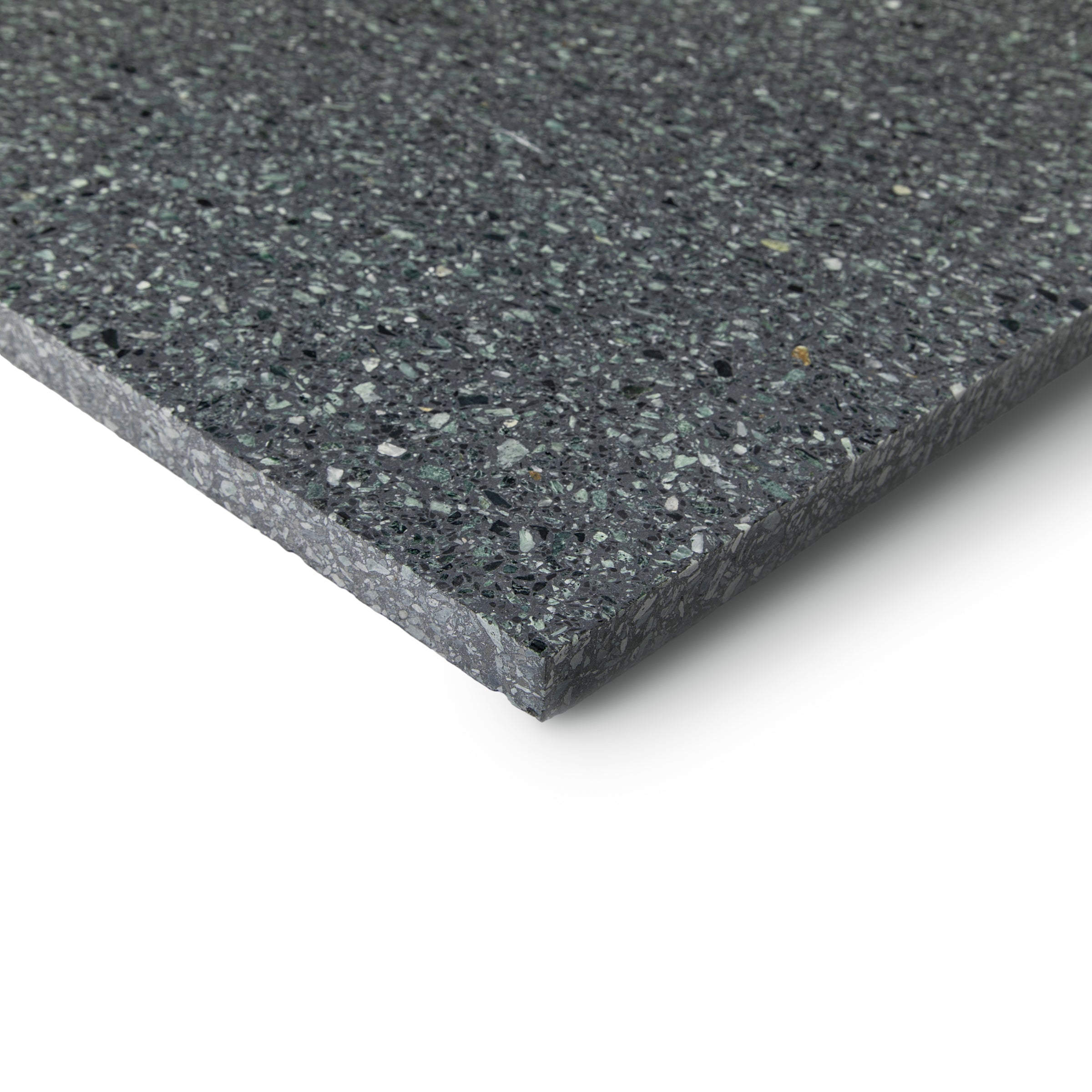 Close-up of a dark speckled tile edge showing its thickness and textured surface pattern
