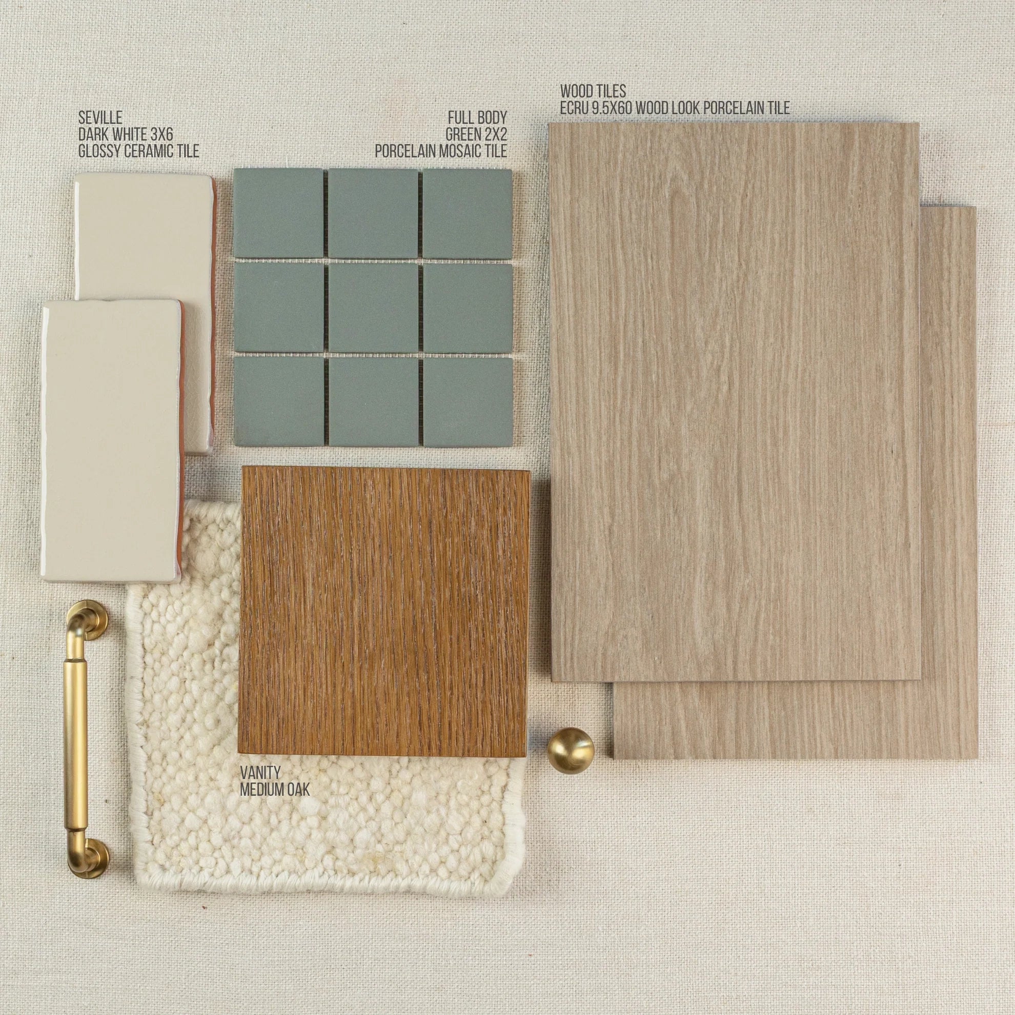 Layout of wood-look porcelain tiles in ecru, green porcelain mosaic, medium oak vanity sample, creamy ceramic tiles, brass hardware, and textured fabric background