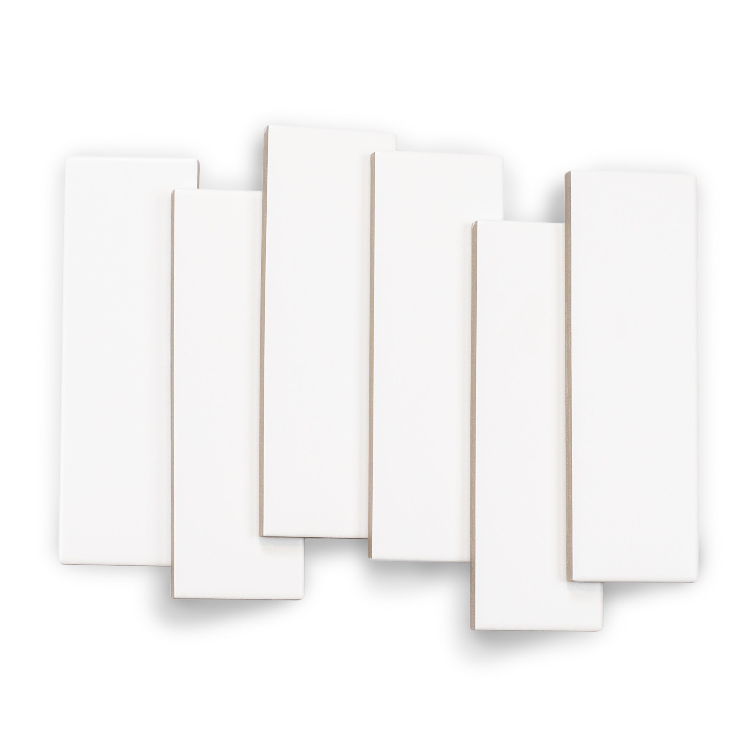Arrangement of matte white porcelain tiles with clean edges and smooth surfaces on a white background