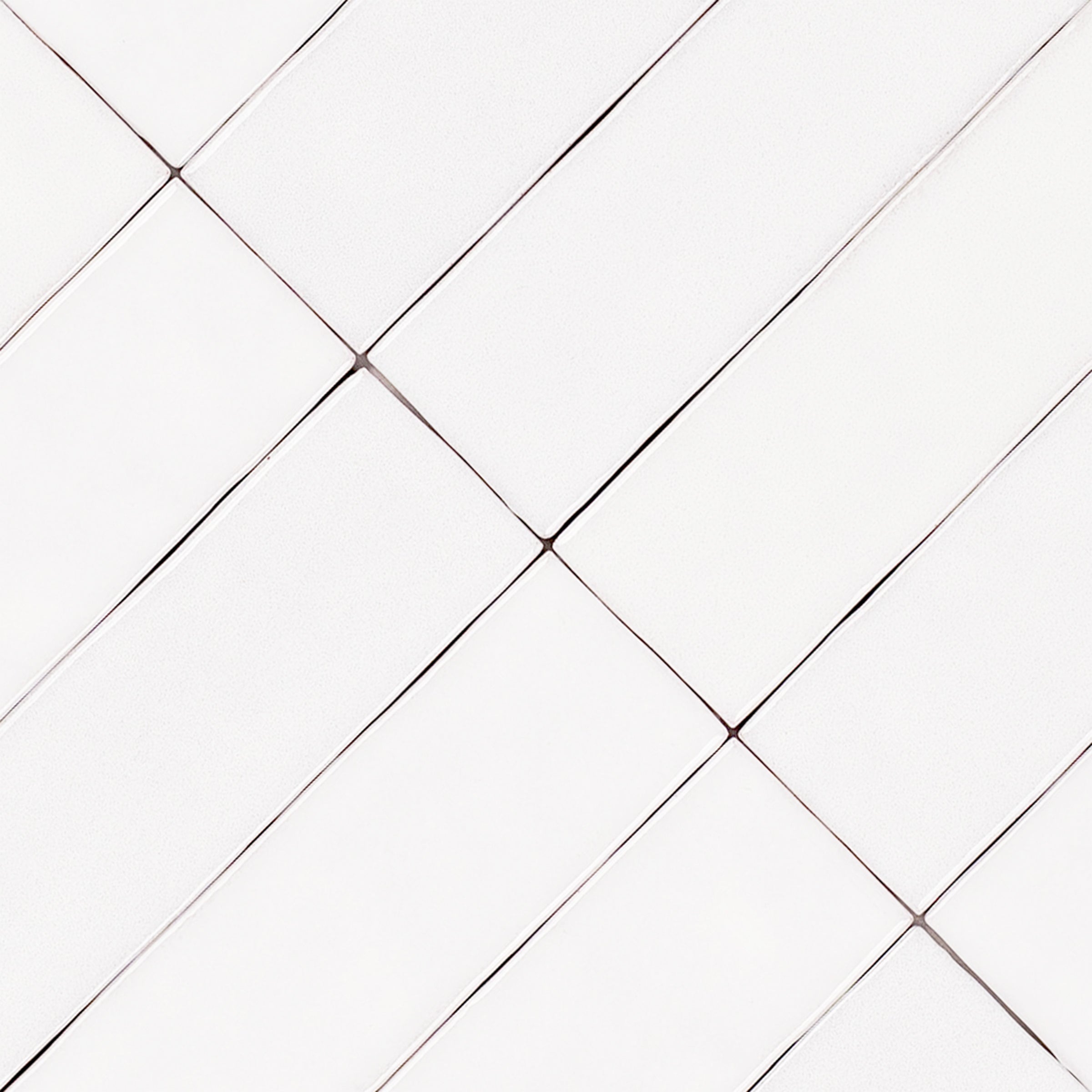 White Glossy Ceramic Tile in 2x8 format with handcrafted zellige-inspired texture from Small Format Tiles collection