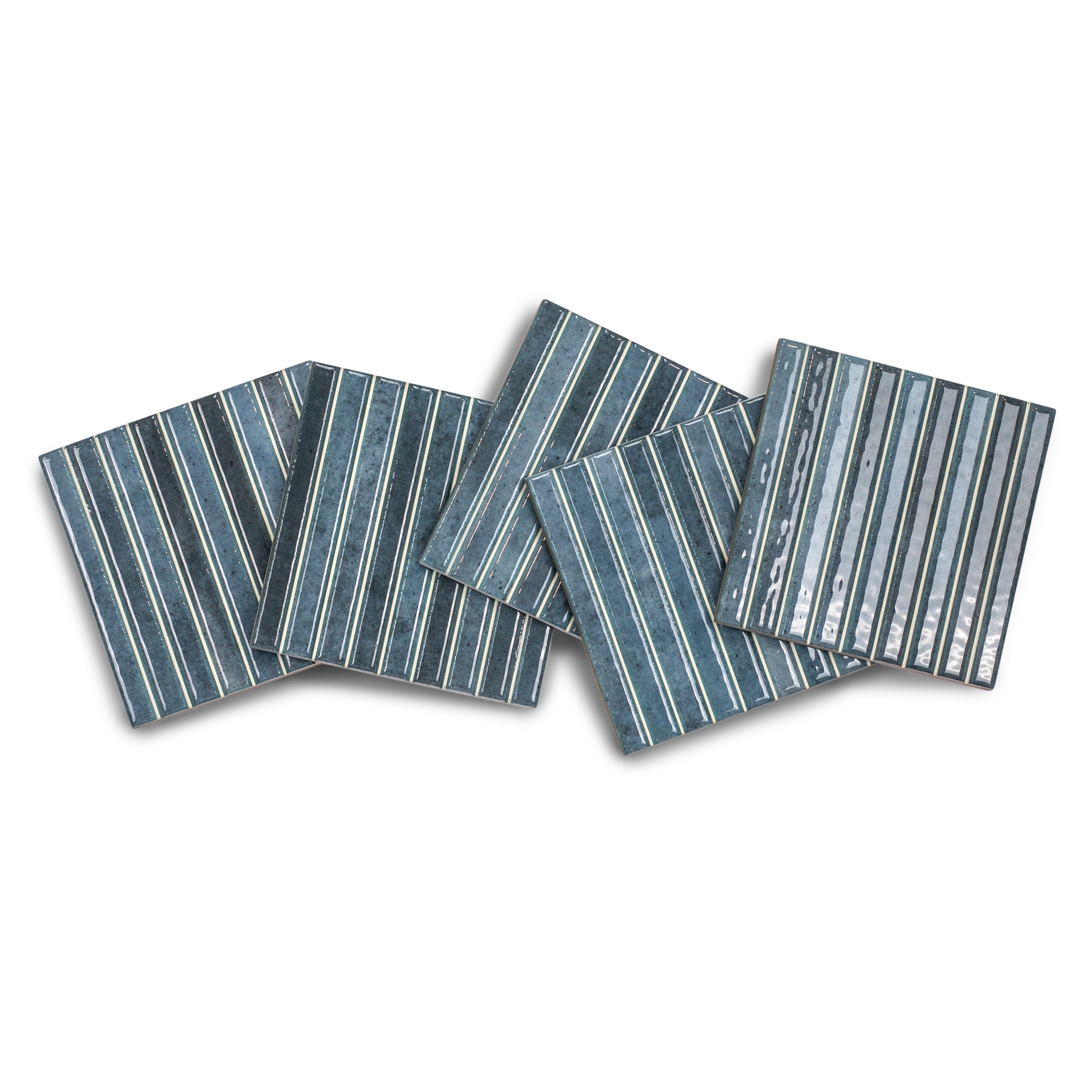 Glossy ceramic small format tiles in varying blue tones with thin vertical white stripes arranged overlapping on white background