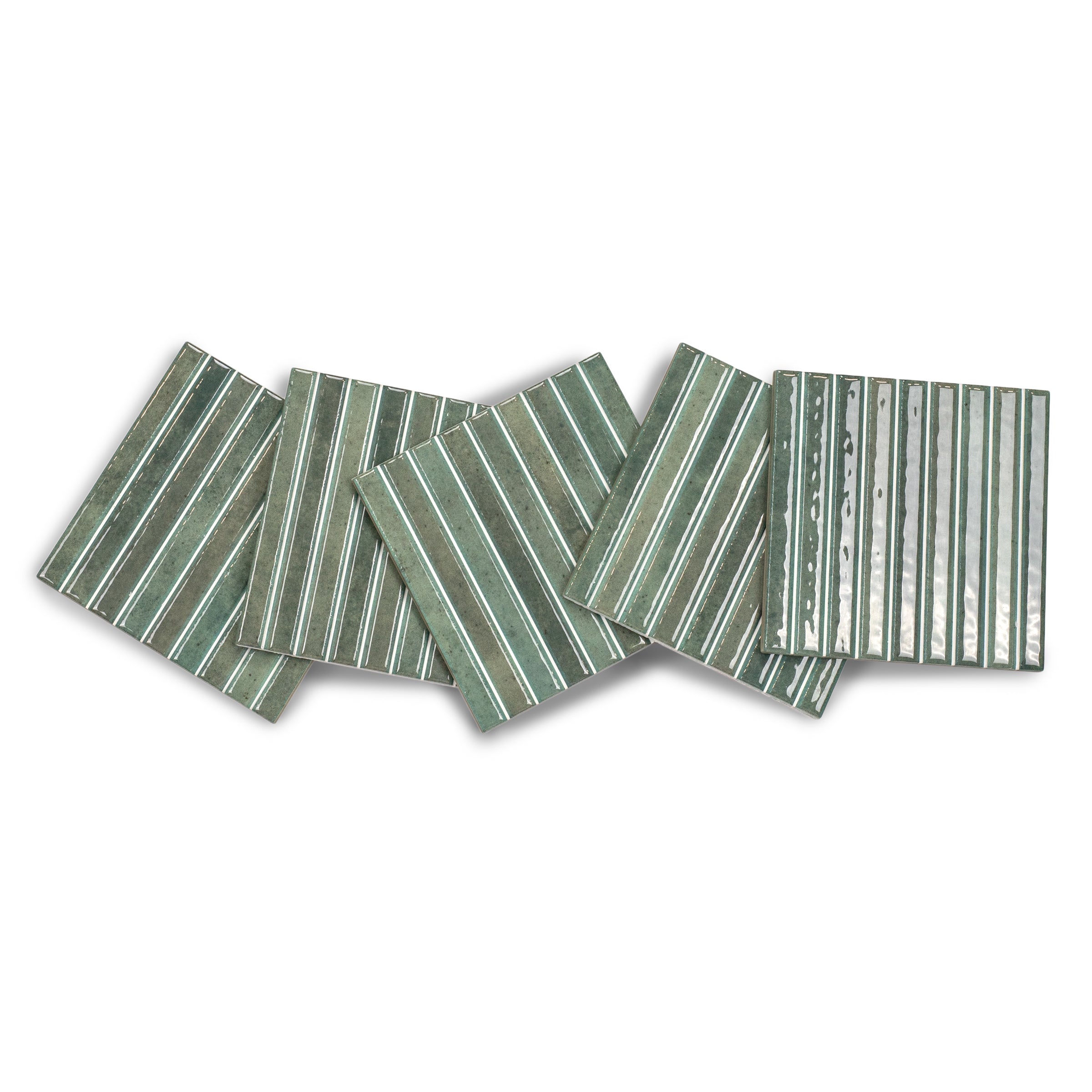 Set of green ceramic tiles featuring raised vertical stripes with a glossy finish on a white background