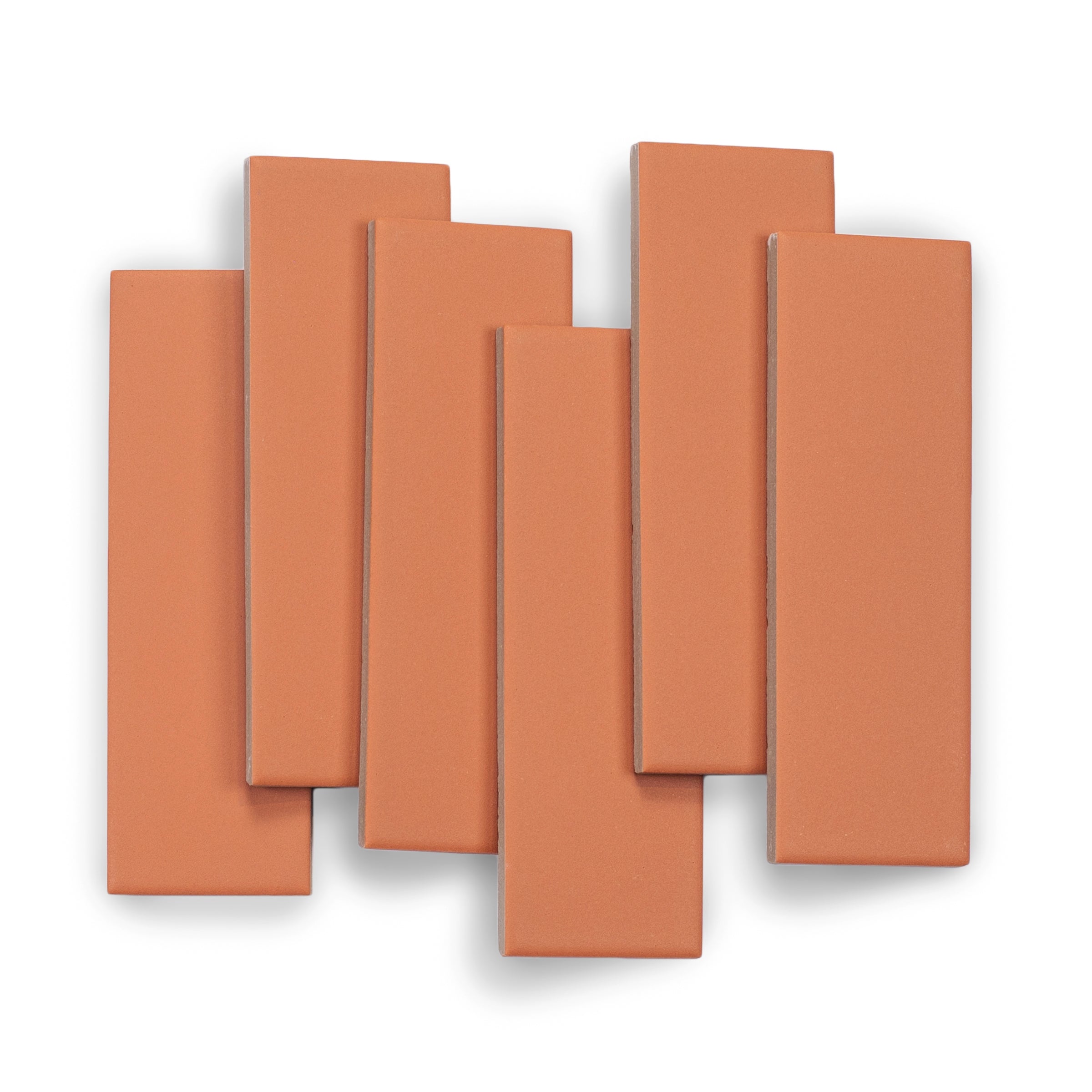 Matte burnt orange rectangular ceramic tiles with smooth surface and clean edges arranged in a layered pattern