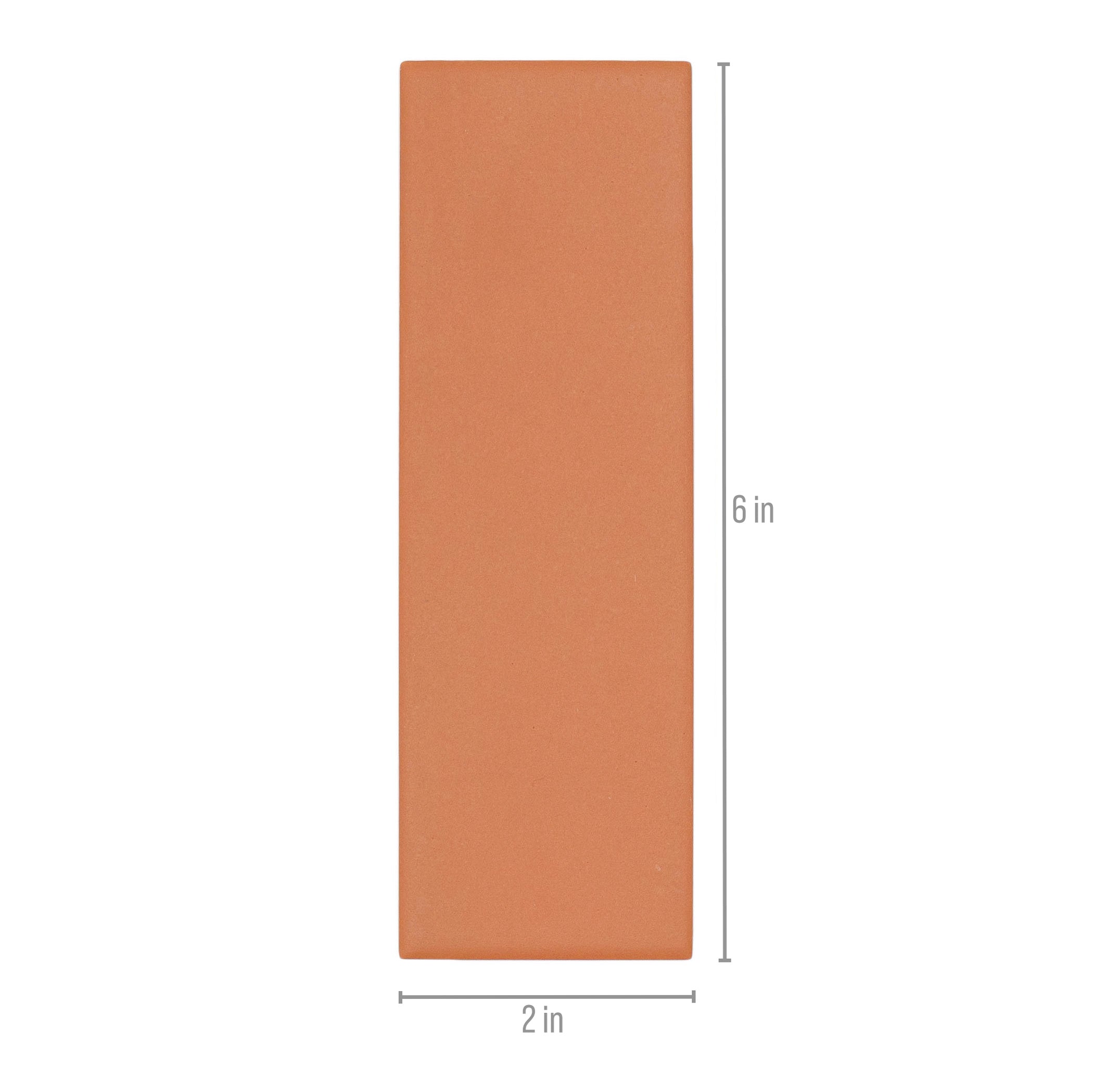 Matte burnt orange rectangular ceramic tile with smooth finish and clean edges measuring 2 by 6 inches for versatile use